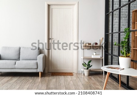 Wooden bookcase in interior of modern living room Royalty-Free Stock Photo #2108408741