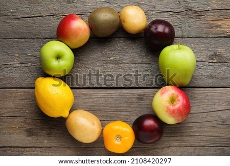 Frame made of fresh fruits and vegetables on wooden background. Vegan Day