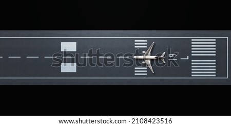 Top view of airplane model on the runway, flat lay design. Royalty-Free Stock Photo #2108423516