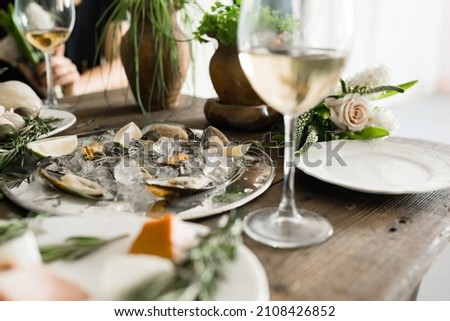 Wedding dinner. Table with beautiful decorations. Nice colors. Dishes and glasses. Flowers and food. Catering. Stylish and colorful picture.