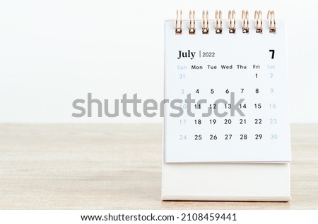 The July 2022 desk calendar on the table.