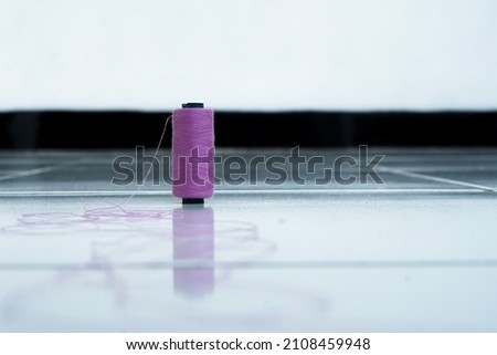 Selected focus photo purple sewing thread on white floor