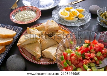 A healthy Mediterranean diet. Israeli breakfast. Vegetable salad, eggs, pastries, bread. High quality photo