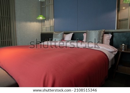 
Elegant and comfortable home and hotel bedroom interior.There's a nice rug and a bedside lamp.