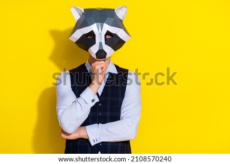 Photo of minded serious smart raccoon man think finger chin wear polygonal mask vest isolated yellow color background