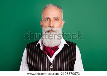 Photo of aged handsome man serious confident classy outfit rich isolated over green color background