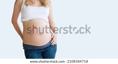 Picture on the belly of a pregnant woman gender symbol Mars. Soon will be born a boy.