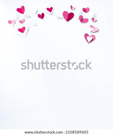 Valentines Day or wedding, invitation, scattered painted small cut out red, pink and white hearts, vertical with copy space
