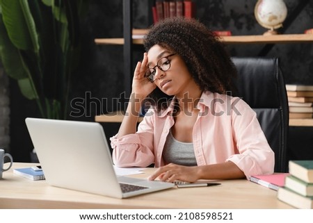 Exhausted tired sad depressed ill overworked young african woman tutor student freelancer having problems at work, suffering from headache, migraine at workplace office. Royalty-Free Stock Photo #2108598521