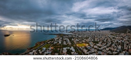 Wide, aerial panorama of the southern suburbs of Athens, Voula, Glyfada and Elliniko, Greece, during a cloud evening Royalty-Free Stock Photo #2108604806