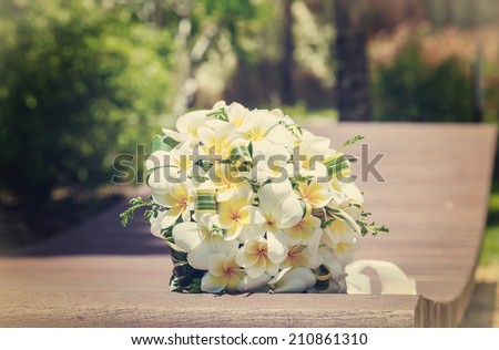 wedding bouquet of frangipani on the bench