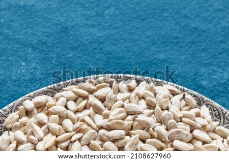 Close up picture of raw sunflower seed kernels, selective focus, space for text.