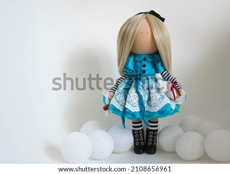 beautiful doll Alice in Wonderland in a blue dress