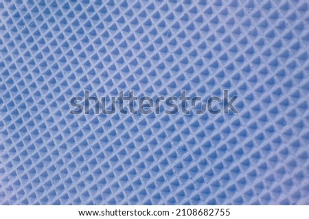 waffle cake close up. blue checkered background. geometric volumetric texture.