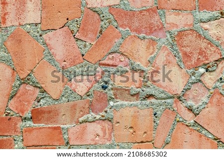 Mosaic elements in the old historical architecture of the urban environment. Rough textured background with copy space for text or lettering. Underlay blank or graphic design resource