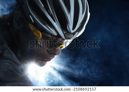 Dramatic colorful close-up Cyclist  portrait. Sport background with copyspace.  Royalty-Free Stock Photo #2108692157