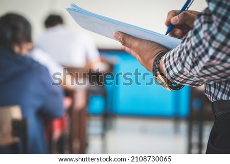 The teacher controls the exam room for students to take the exam in the classroom Royalty-Free Stock Photo #2108730065