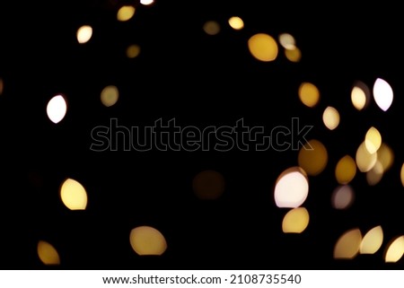 Banner made with gold light blurred. Abstract boken texture. Festive background. Glitter light spots on black background. Royalty-Free Stock Photo #2108735540