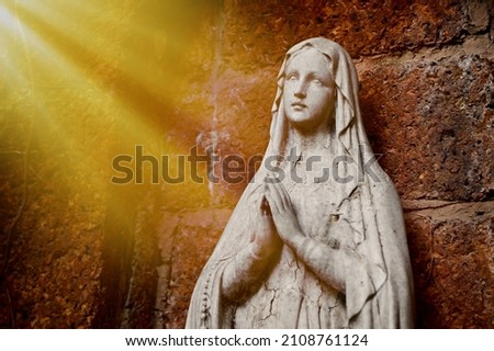 Statue of Our lady of grace virgin Mary view with natural background in the rock cave at Thailand. selective focus. Royalty-Free Stock Photo #2108761124