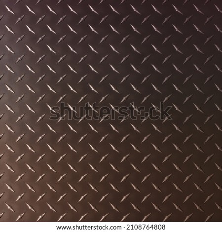 brown iron plate with diamond texture, dark metal background.