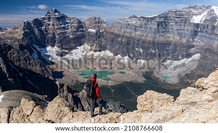 Climber standing on top of Mount Temple looking down to Paradise Valley, Banff National Park, Alberta, Canada. Royalty-Free Stock Photo #2108766608