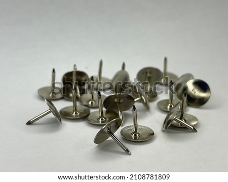 A thumbtack for sticking paper on the wall Royalty-Free Stock Photo #2108781809
