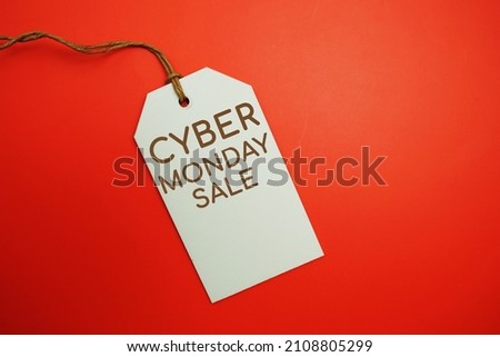 Flat lay Cyber Monday Sale tag on red background