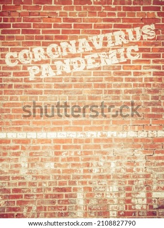 A sign "Coronavirus Pandemic"on brick wall never going away