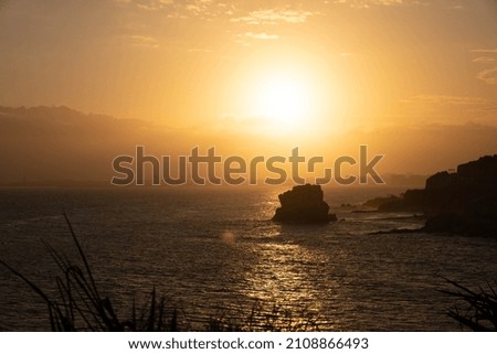 The silhouettes of the cliffs against the bright sunset 