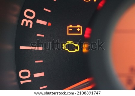 Close up of a battery and engine warning light in a new car
