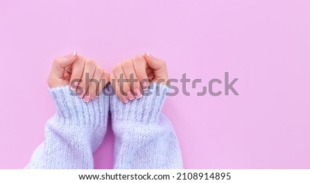 female hands with french manicure on pink background Royalty-Free Stock Photo #2108914895