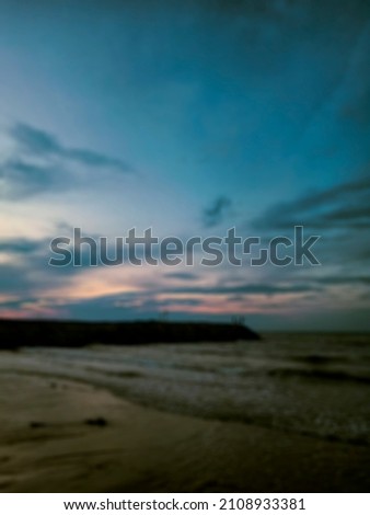 Abstract background of a beach scene with rocks, sand, waves, sea, boats, flak and defocused coastal people activities. suitable for banner backgrounds, images and product editing.