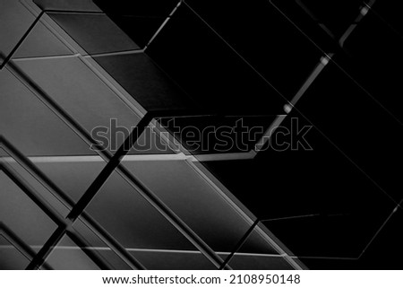 Metal wall panels. Abstract architecture of modern public or office building. Close-up photo of industrial or business real estate. Geometric structure of rectangular tiles and parallel lines.