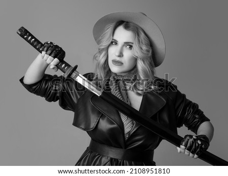 Fashion model. Black and white photo. Half-length monochrome portrait of young beautiful woman posing isolated on gray studio background. Beauty, fashion, style, bodypositive concept