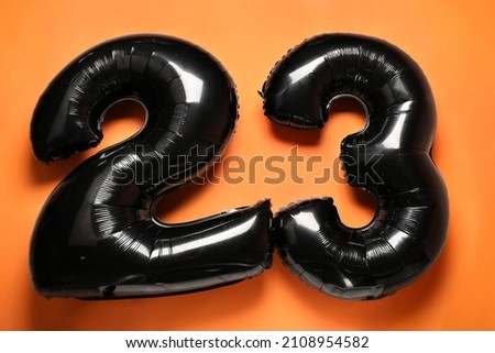 Figure 23 made of balloons on orange background