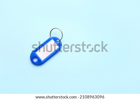 Plastic key tag on blue background