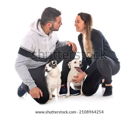 jack russel terriers and couple in front of white background