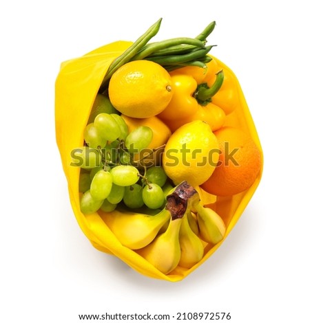 Eco bag with different fruits and vegetables on white background