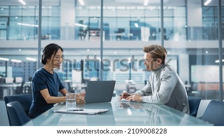 Multiethnic Diverse Office Conference Room Meeting: Team of Two Creative Entrepreneurs Talk, Discuss Growth Strategy. Stylish Young Businesspeople work on Investment and Marketing Projects. Royalty-Free Stock Photo #2109008228