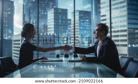 Multiethnic Diverse Office Conference Room Meeting: Team of Two Creative Entrepreneurs Talk, Find Solution and Shake Hands. Stylish Young Businesspeople Work on Digital e-Commerce Startup Project. Royalty-Free Stock Photo #2109022166