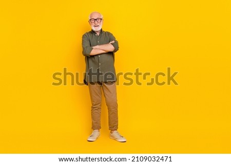 Full body photo of positive aged man folded arms have good mood isolated on yellow color background