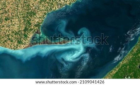 The Great Lakes, Aerial turquoise ocean photo from clear sky, top view of sea texture background, 16:9 ratio wallpaper, blooms of phytoplankton in Great Lakes. Elements of this image furnished by NASA Royalty-Free Stock Photo #2109041426