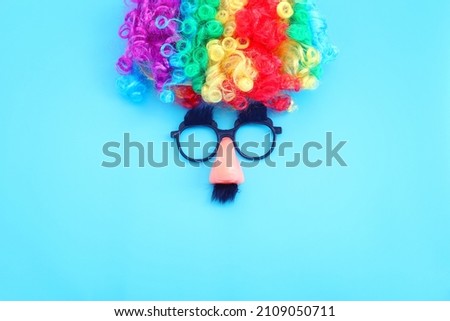 carnival, party and Purim celebration concept (jewish carnival holiday) over blue background