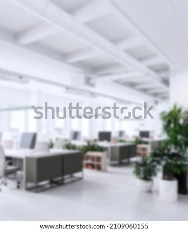 Modern business office without people with blurred bokeh background. tables, chairs, computers. copy space. High quality photo Royalty-Free Stock Photo #2109060155
