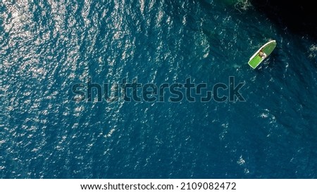 Green boat on blue water