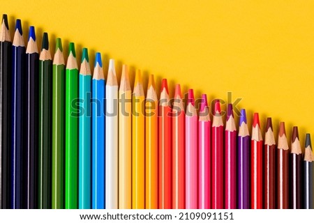 Color pencils set, row wooden color pencils, colored pencils for drawing. Multicolored pencils on a yellow background Royalty-Free Stock Photo #2109091151