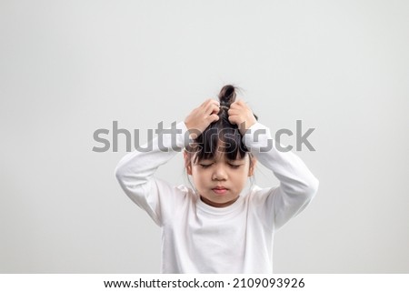 Sad little girl holds his head. little girl feeling sick, having headache. Royalty-Free Stock Photo #2109093926