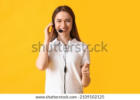 Female technical support agent showing thumb-up on color background Royalty-Free Stock Photo #2109102125