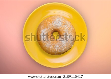 Tasty sweet donut for Hanukkah on color background