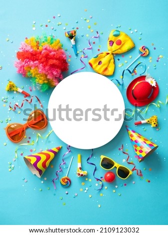 Colorful party items for carnival or birthday party on blue background with copy space Royalty-Free Stock Photo #2109123032